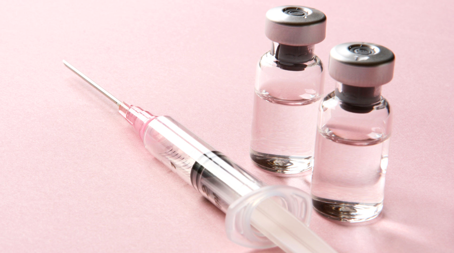 a syringe and vaccine bottles