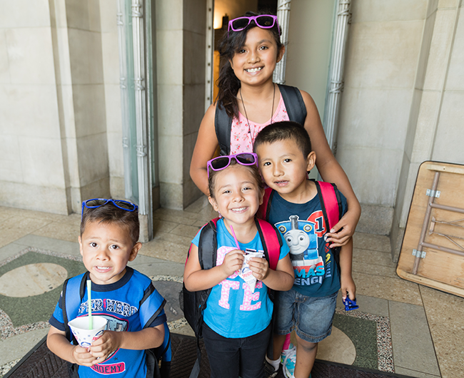 children at backpack giveaway