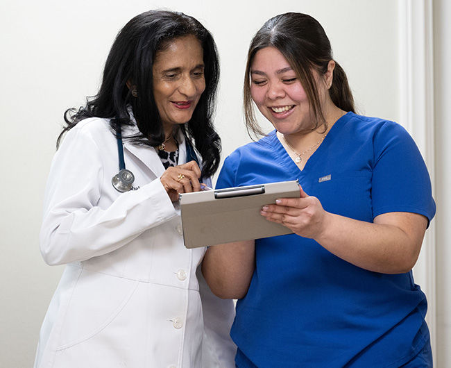 Dr. Mona Shah and nurse viewing tablet