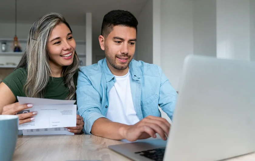 Hispanic couple viewing laptop