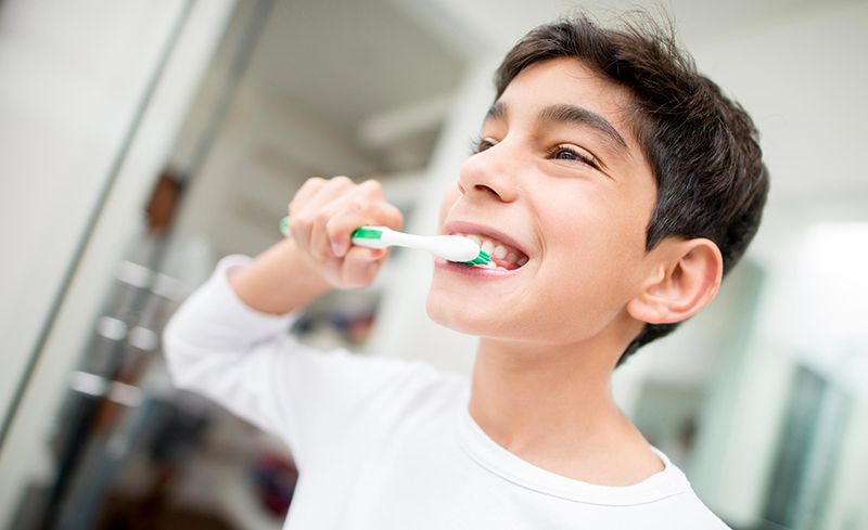 a boy brushing his teeth