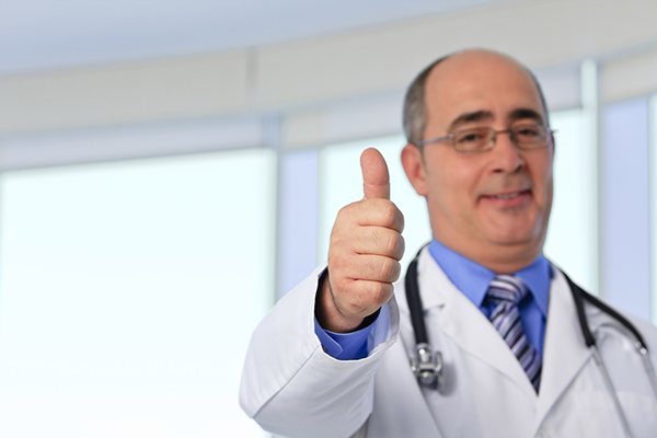 a doctor giving thumbs up