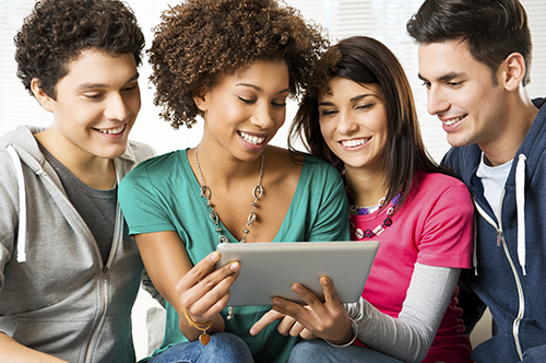 group of friends looking at tablet